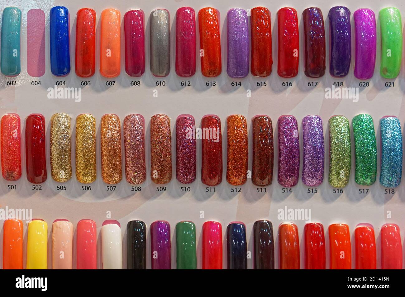 Colorful palette sparkling gel nails samples Stock Photo - Alamy