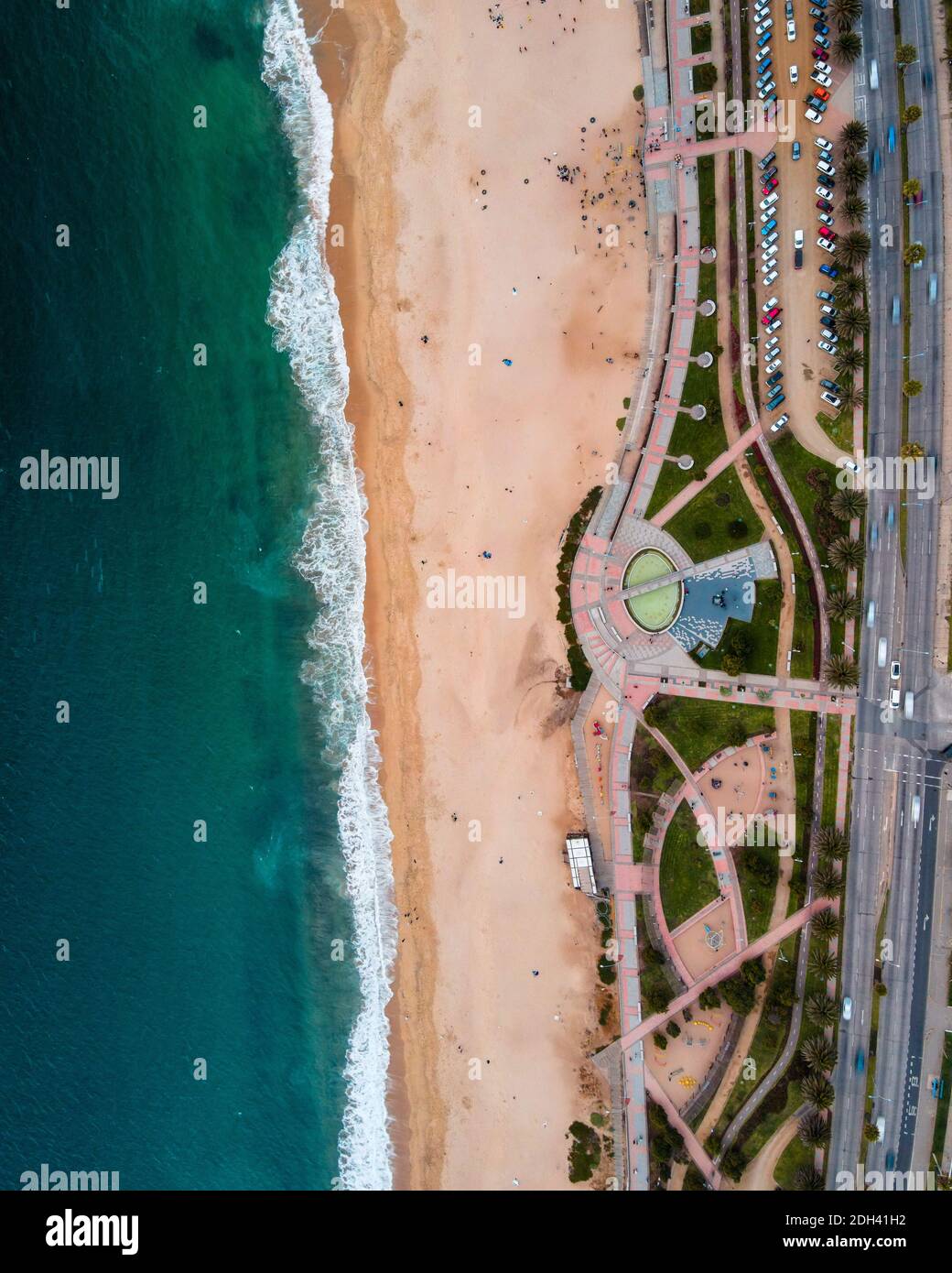 Zenith view of the Del Deporte Beach located in the city of Vina del Mar, Chile with waves of the sea and people playing on the sand Stock Photo