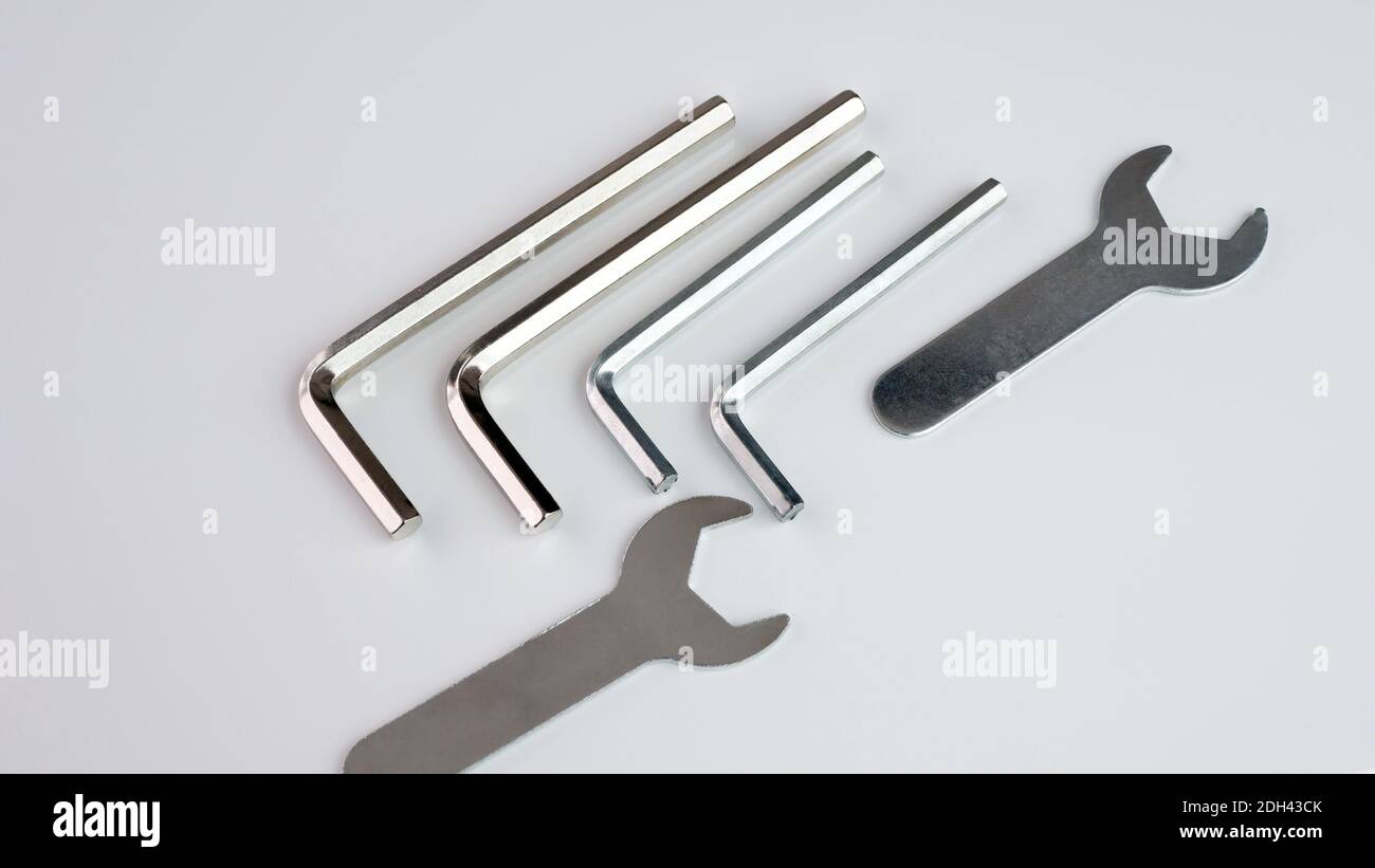 A set of wrenches and hexagons. Two wrenches with hex key on white