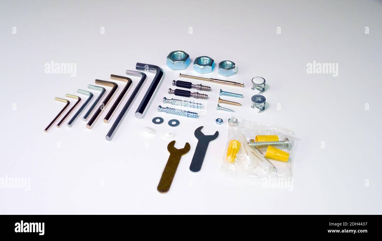Nuts, hex keys and furniture fittings. Set of furniture fittings tools