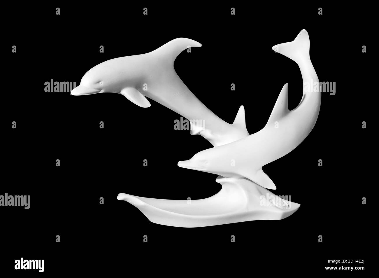 Statue of dolphins on a black background Stock Photo
