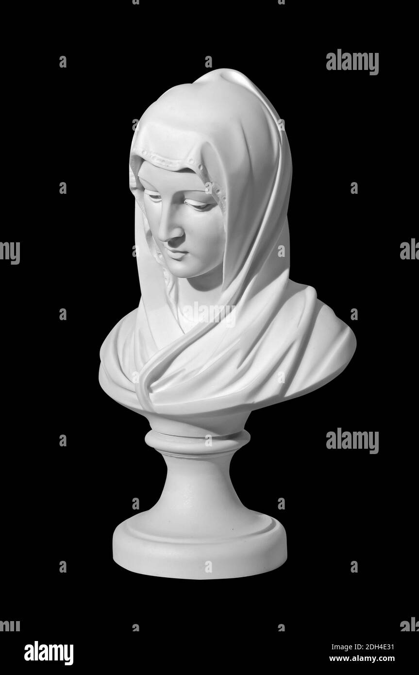 Statue of a religious young woman praying isolated on a black background Stock Photo