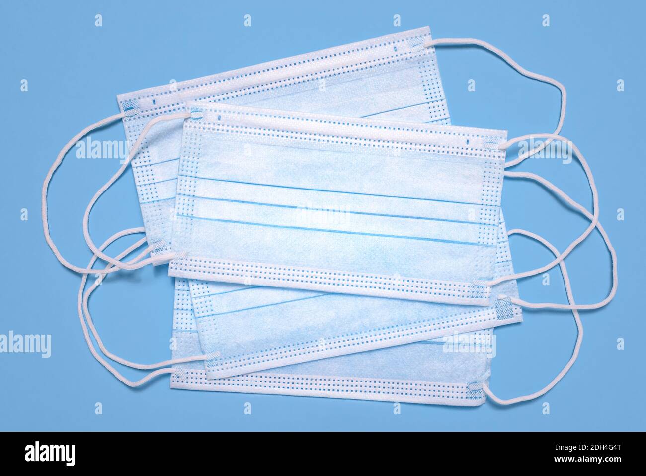 Medical surgical protective face masks on light blue background Stock ...