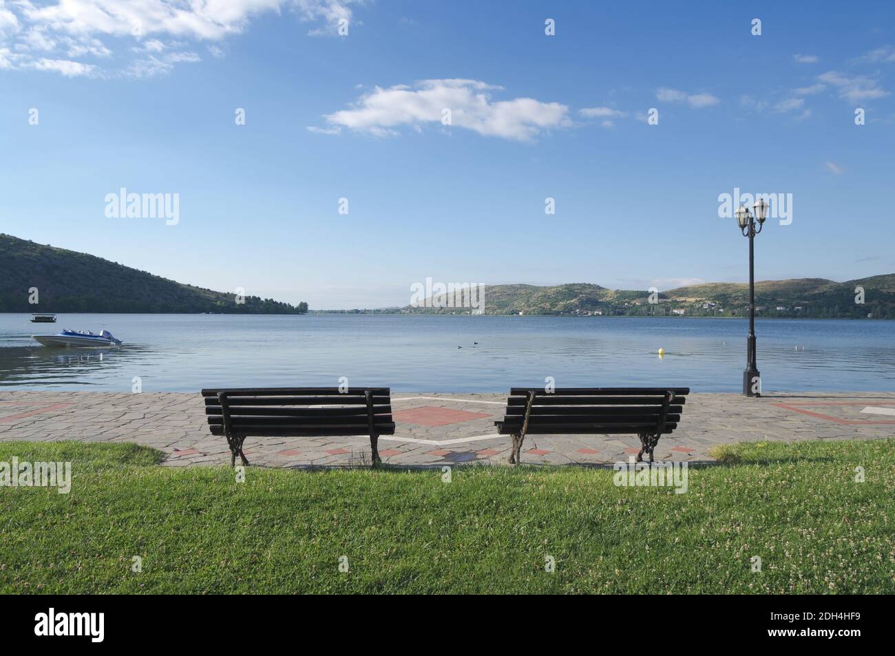 two benches with a view of a lake in the luminous landscape Stock Photo