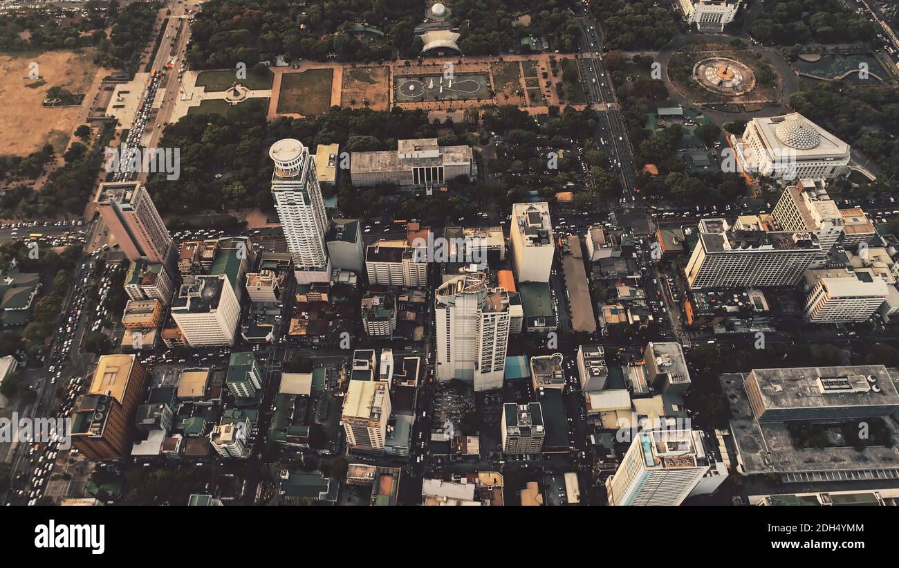 Top down of skyscrapers roofs aerial. Cityscape of metropolis city Manila. Modern architecture at downtown streets. Majestic Philippines capital town. Traffic roads with cars at block houses, cottages Stock Photo