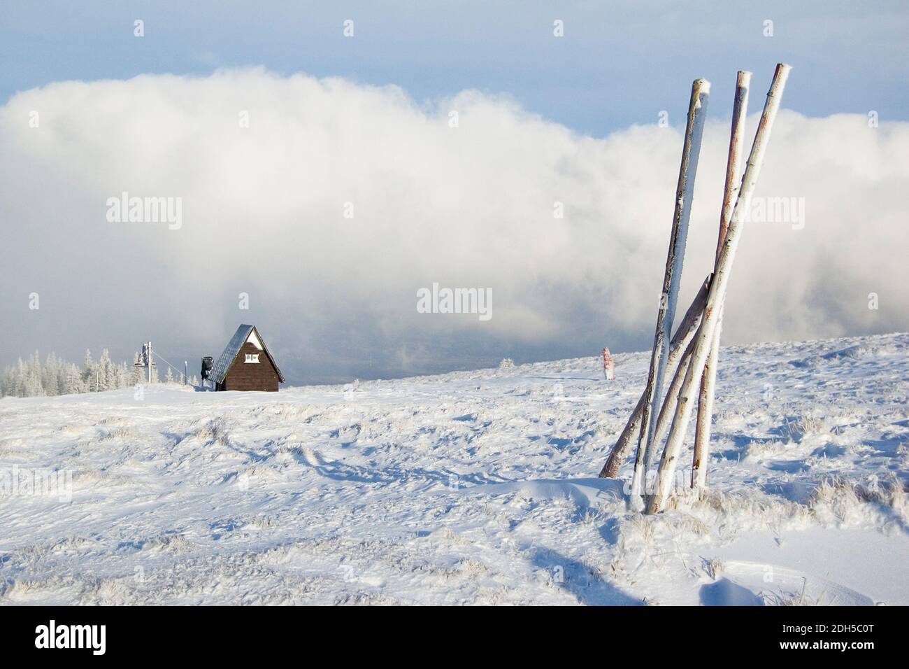 Winter scenery in the mountains with a wooden house covered with snow ...