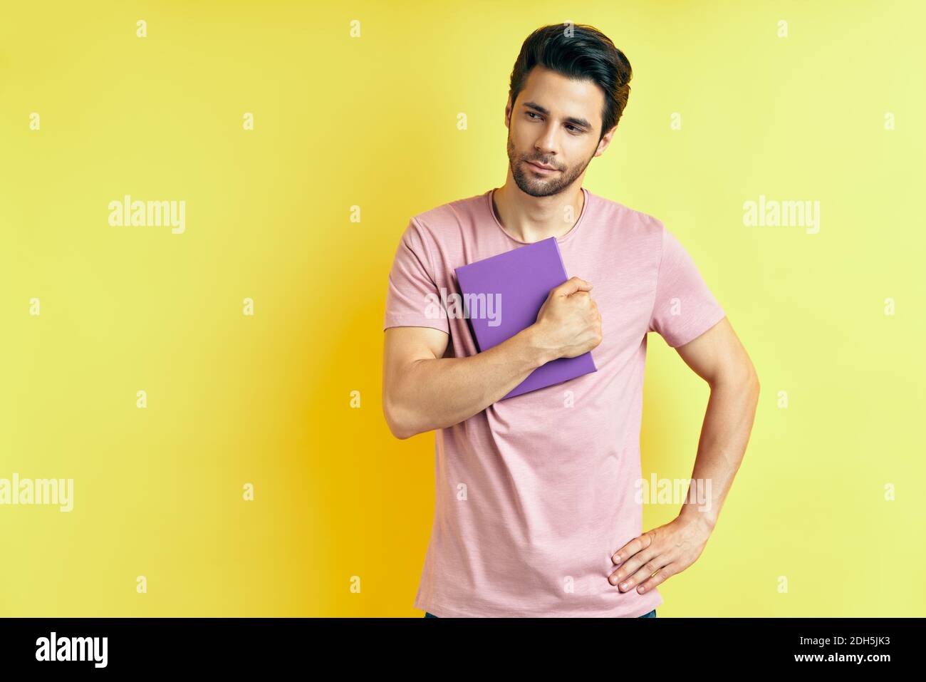 Portrait of young handsome man with book Stock Photo