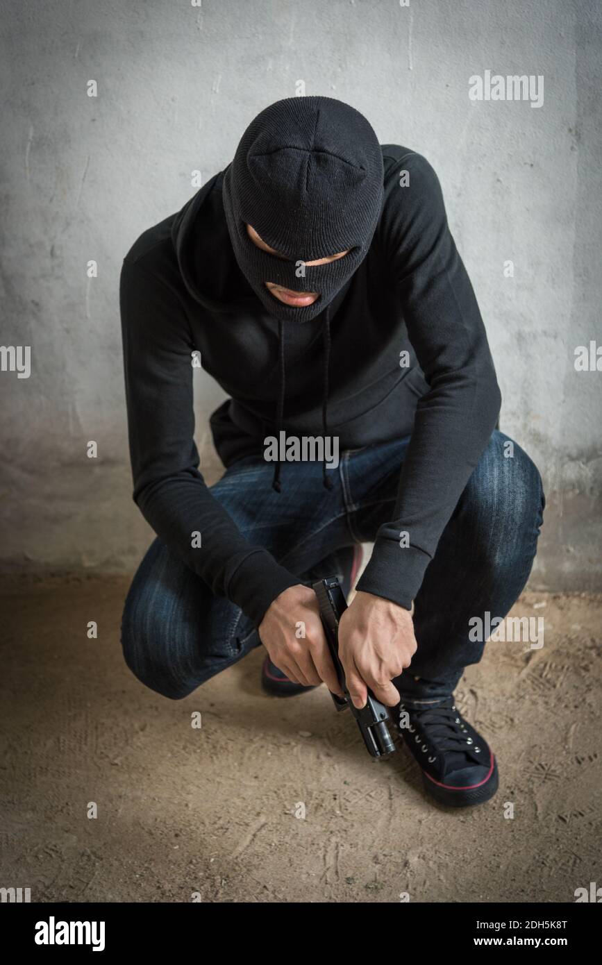 Portrait robbery man is holding gun on hand, kidnapping Thief robber