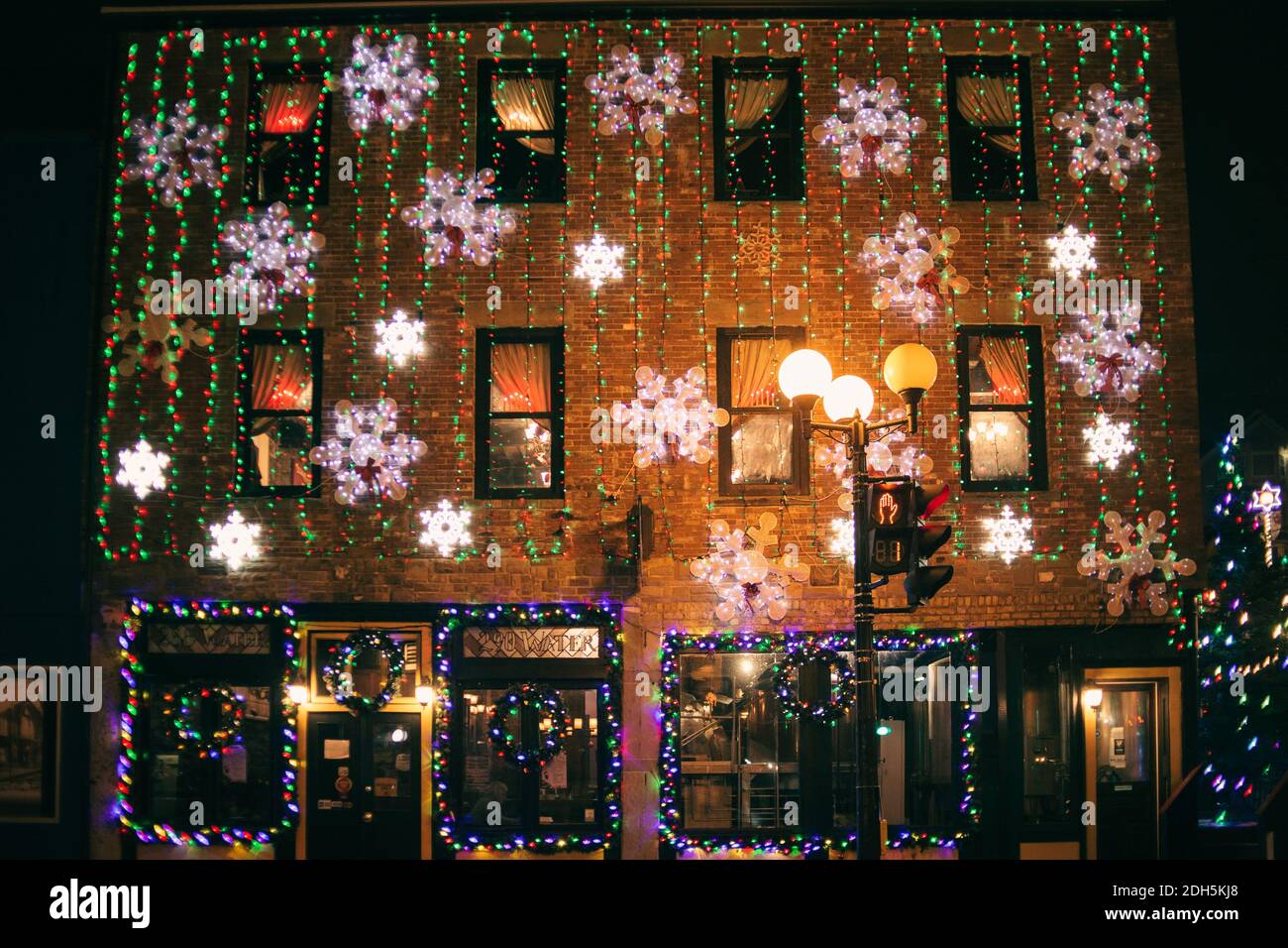 christmas lights on a brick public building at night Stock Photo