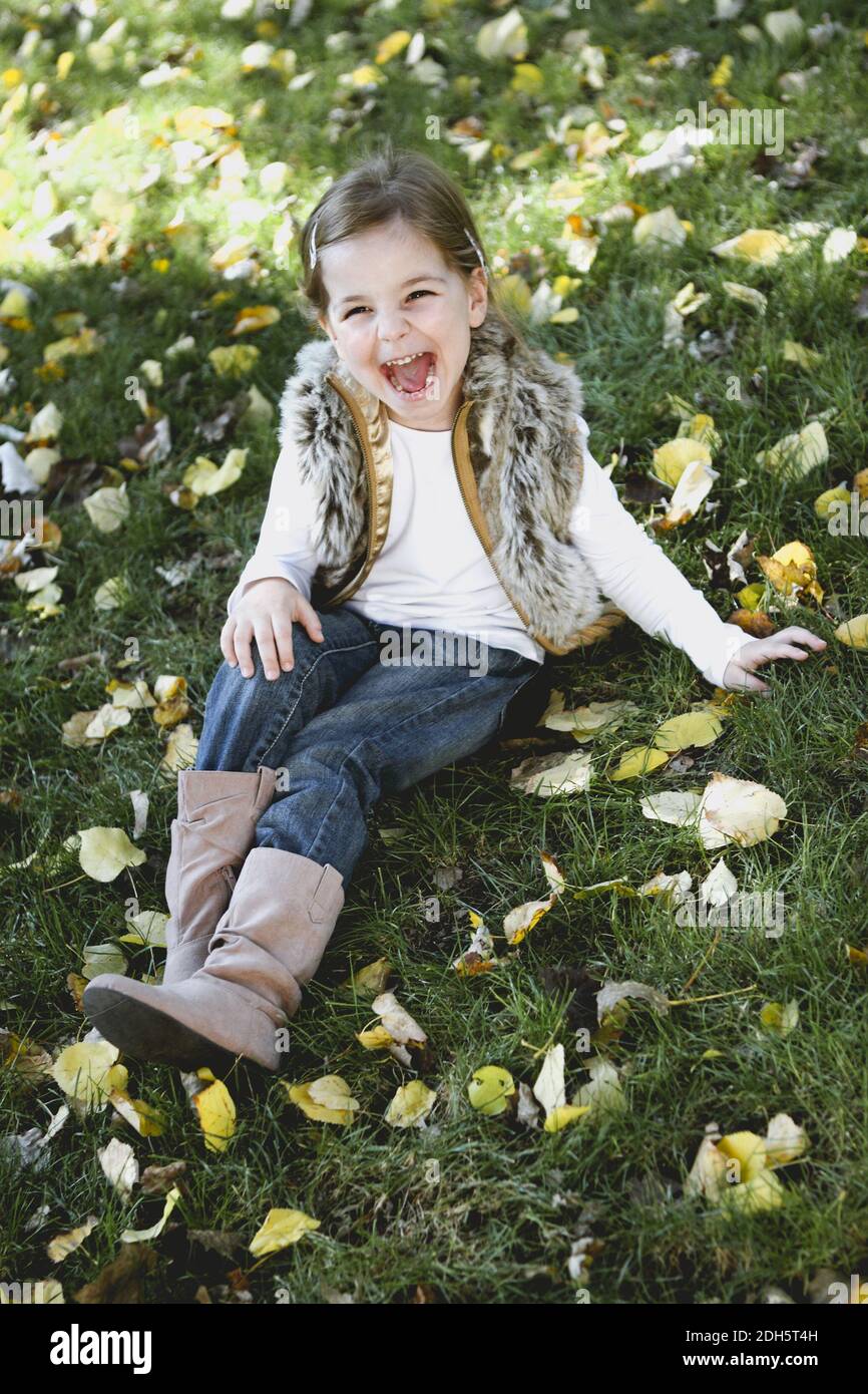 Happy little girl at autumn park Stock Photo - Alamy