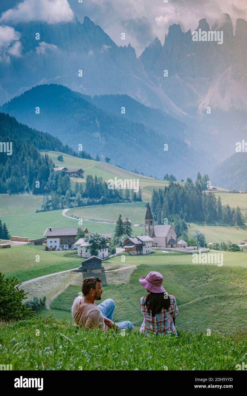 Couple on vacation in the Dolomites Italy, Santa Magdalena Village in Dolomites area Italy Val di Funes Stock Photo