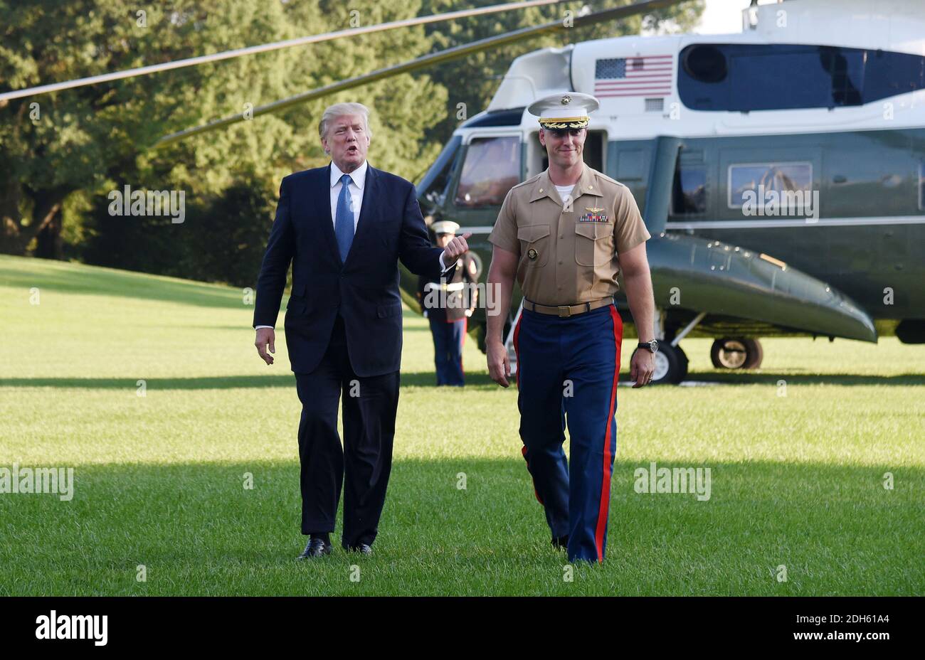 US President Donald Trump walks toward the White House with pilote James Thompson Jr. after completing his last Marine One flight on the South Lawn of the White House on September 24, 2017 in Washington, DC. .Photo by Olivier Douliery/ Abaca Press Stock Photo