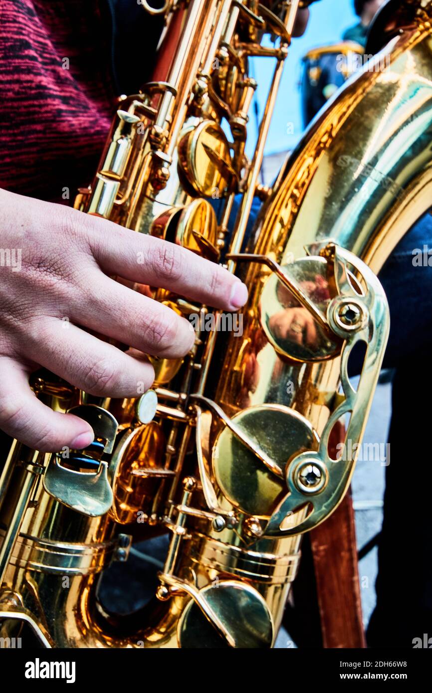 hand and golden saxophone details in a band, music show Stock Photo