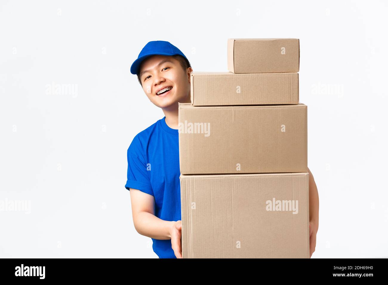Online shopping, fast shipping concept. Smiling happy asian delivery man in blue courier uniform