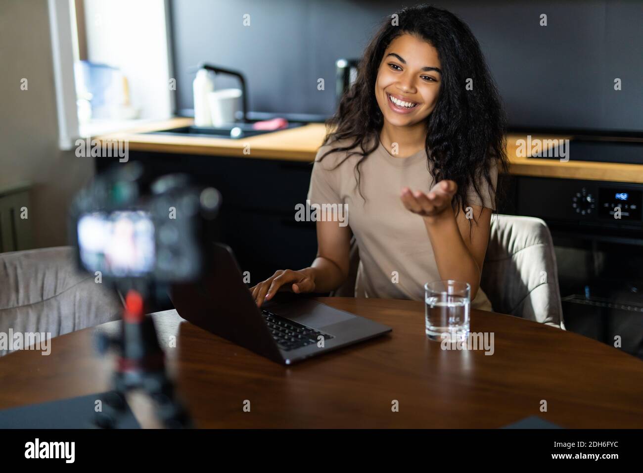 African-American blogger recording video about sport and healthy food ...