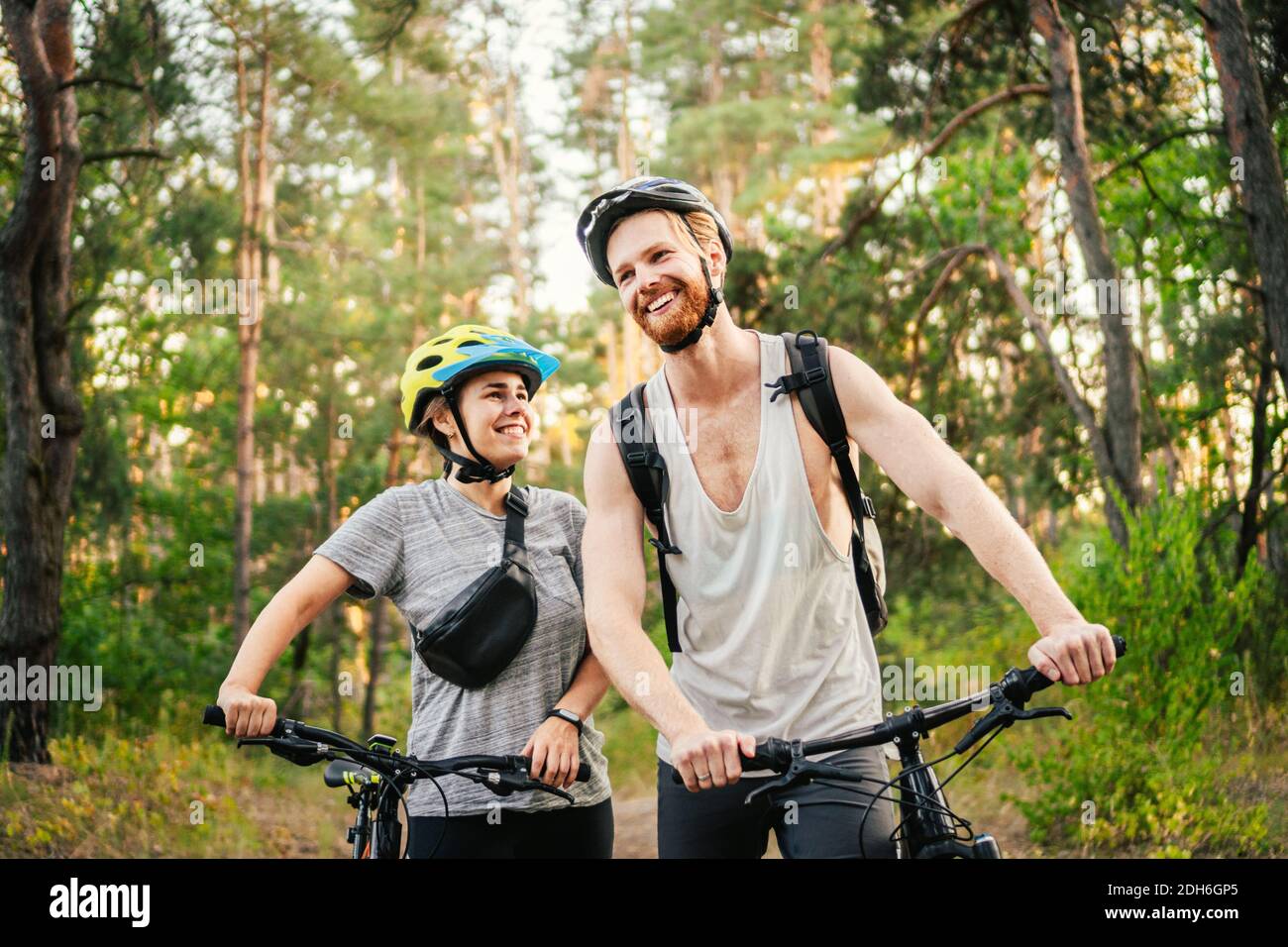 Cycling People. Couple cycle MTB trail track. Outdoor sport activity. Couple With Bikes In Forest. Together on cycle ride in cou Stock Photo