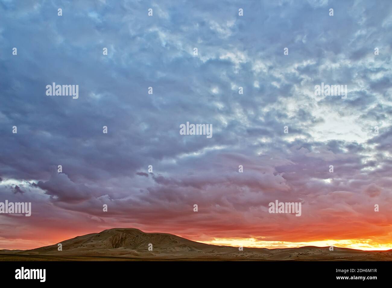 Evening cloudy sky over the sand dunes. Stock Photo