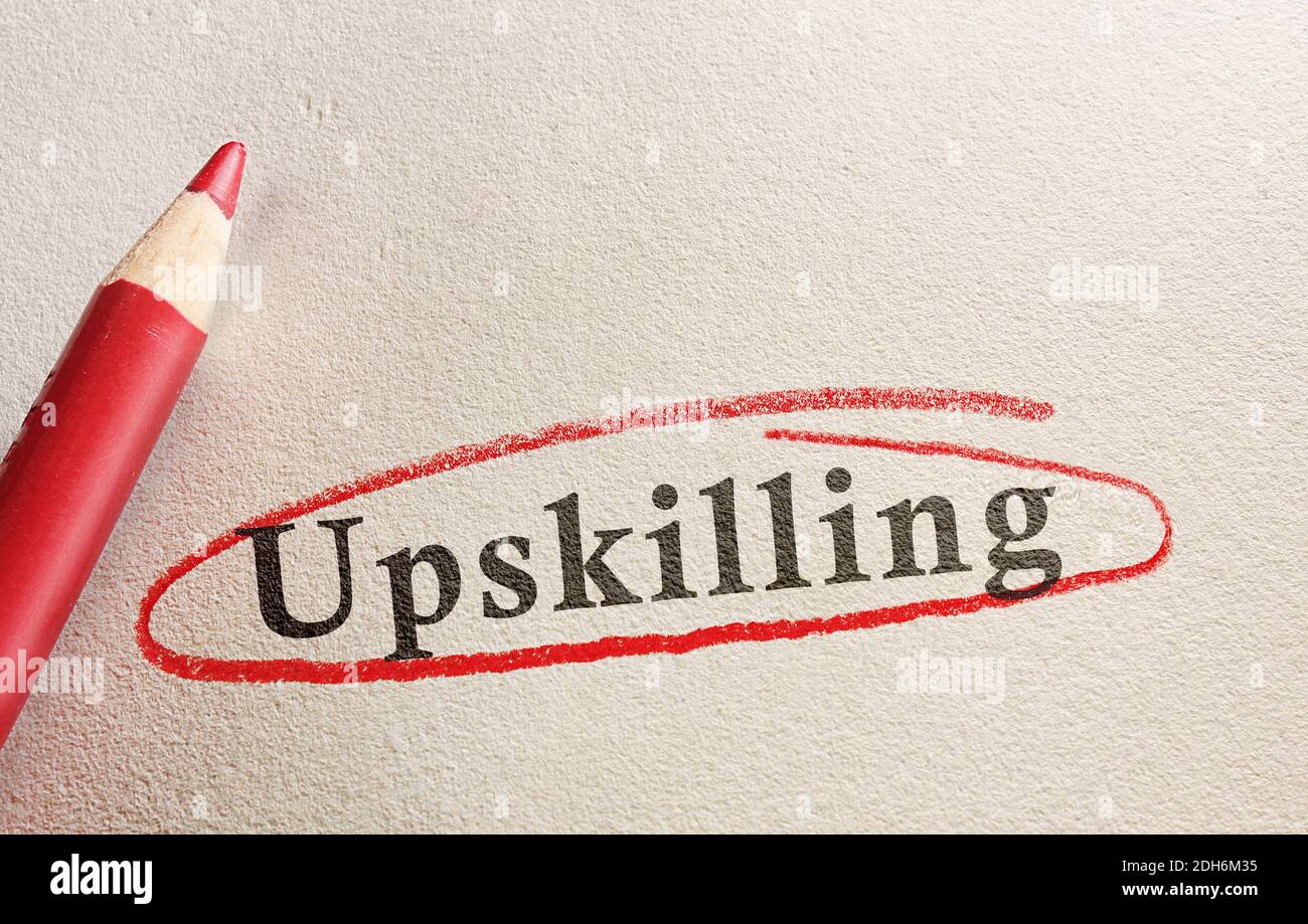 Upskilling text on paper circled in red pencil -- job training concept Stock Photo