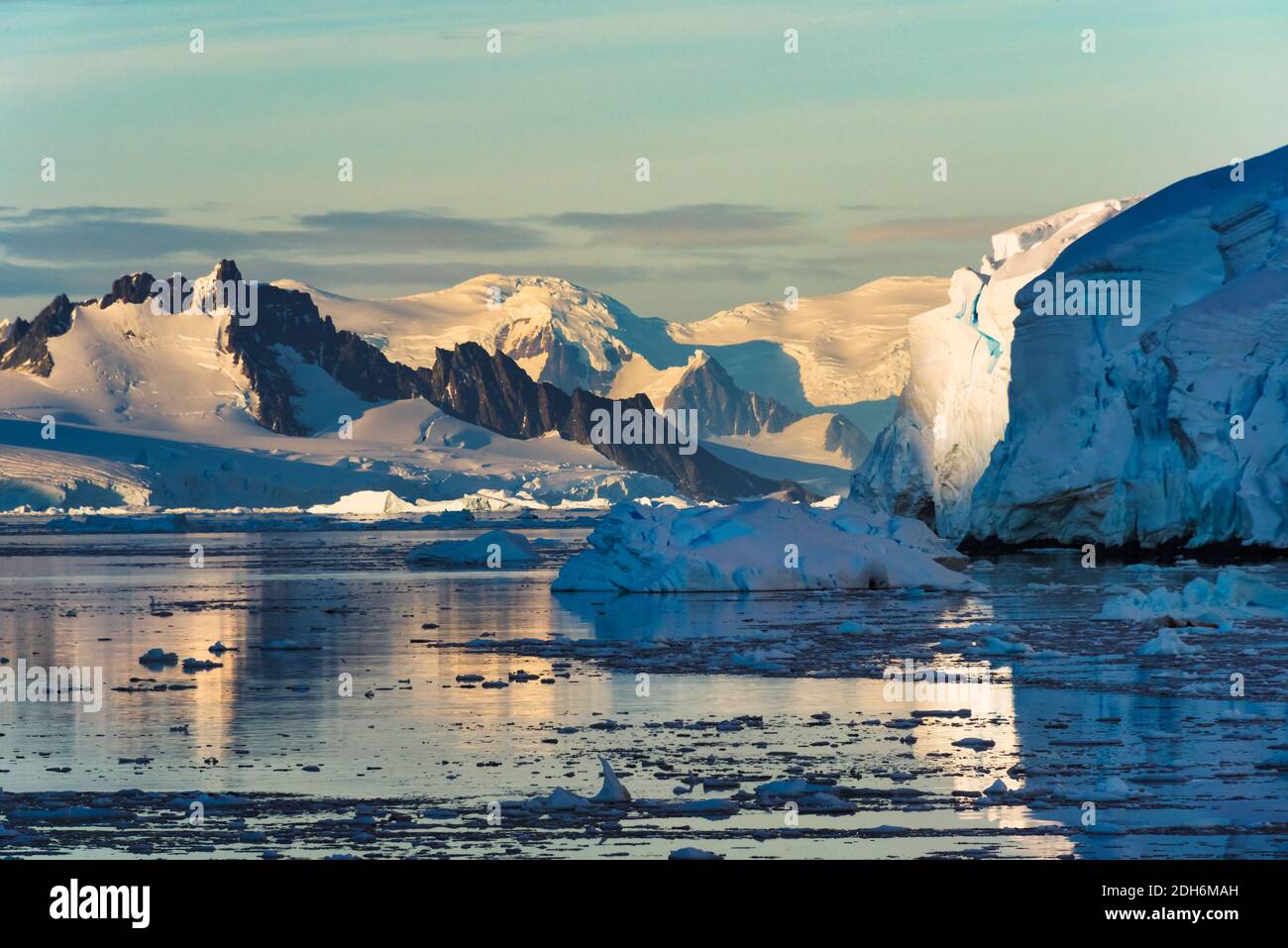 Snow covered island and floating ice in South Atlantic Ocean, Antarctica Stock Photo