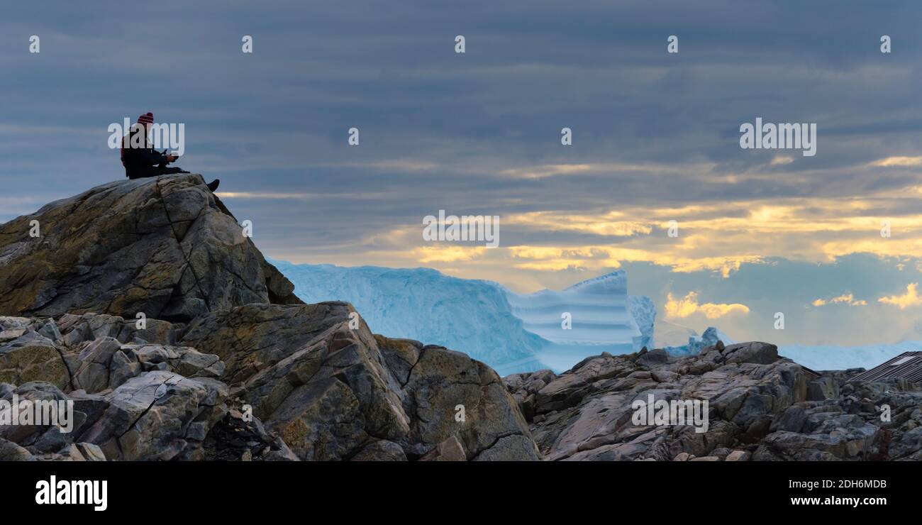 Tourist watching Northeast Glacier on Stonington Island, Antarctica Stock Photo