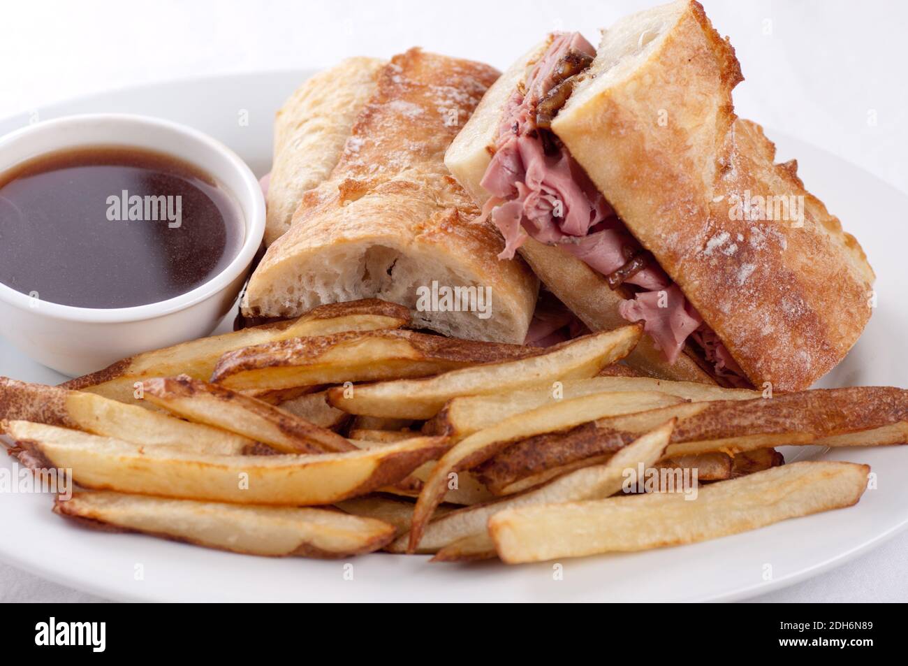 classic french dip au jus or beef dip with fries Stock Photo Alamy