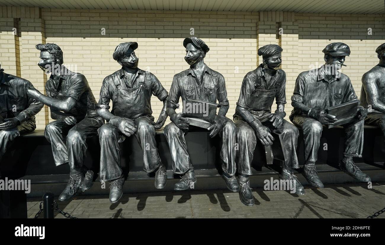 St. Louis, United States. 09th Dec, 2020. Life size figures sitting on a beam now wear masks in front of Cee Kay Supply in St. Louis on Wednesday, December 9, 2020. 'Lunch Atop A Skyscraper' statue was made from a 1932 photograph of 11 men having their lunch on a beam 840 feet above Manhattan, New York on the RCA Building, now GE Building. Photo by Bill Greenblatt/UPI Credit: UPI/Alamy Live News Stock Photo