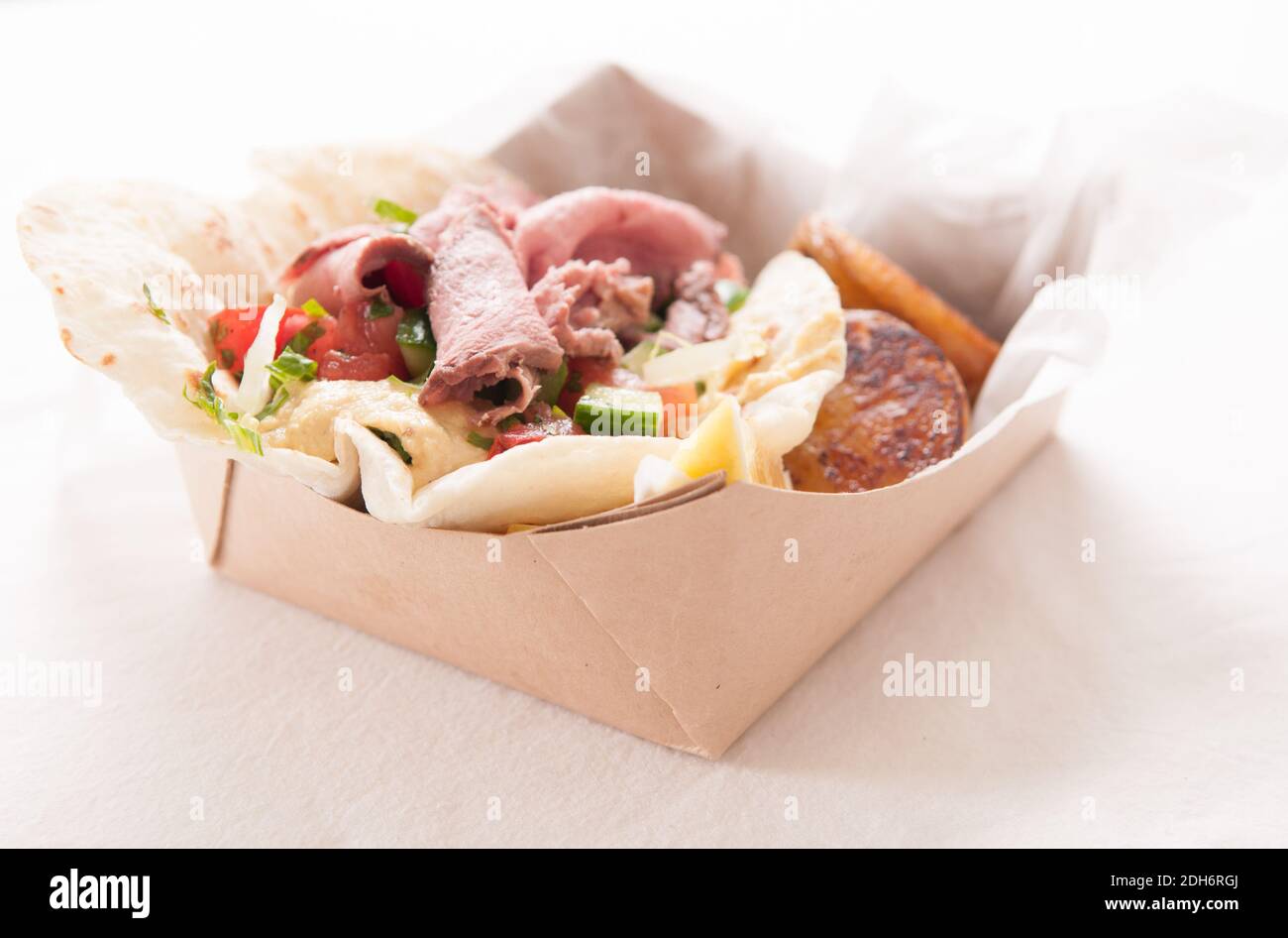 food truck meal of lamb wrap with roasted potato, shawarma style with