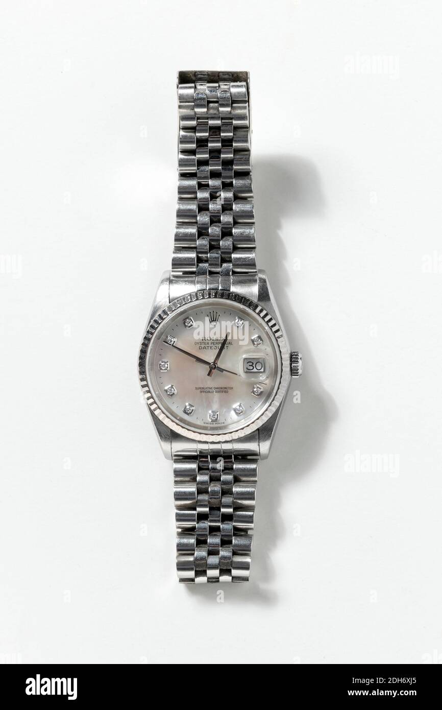 Rolex Oyster Perpetual Datejust Pearl wrist watch with diamonds, resting on white background with shadow, viewed from above Stock Photo