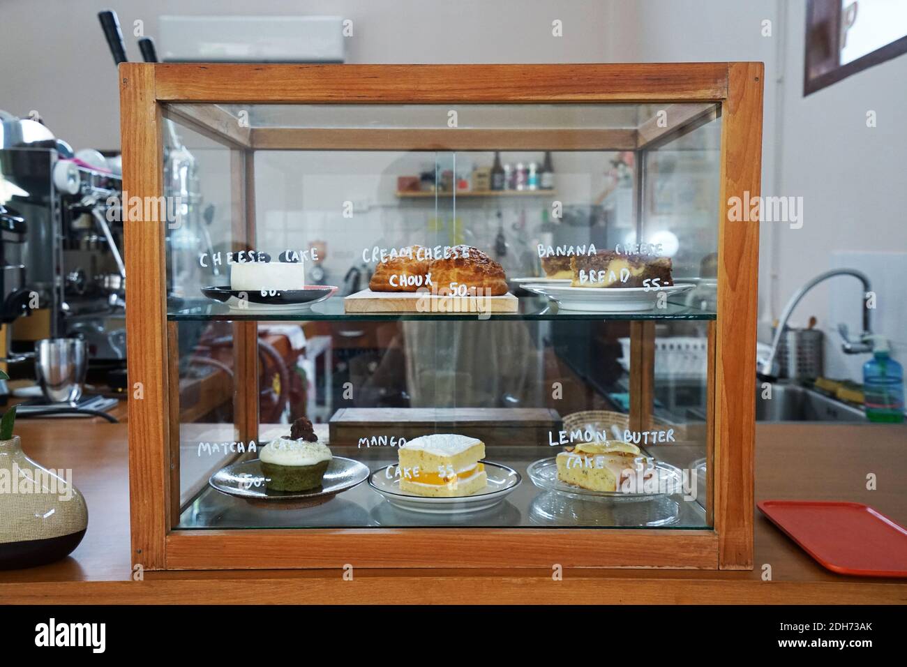 A Wooden Display Case Box Filled With Choux Cream Lemon Butter Cake Mango Short Cake Matcha Green Tea Cupcake And Banana Cheese Bread Stock Photo Alamy