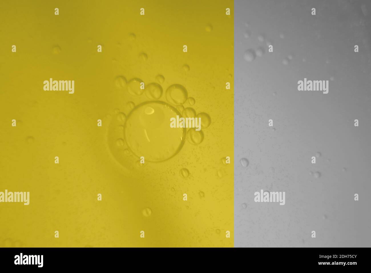 Macro fluid with bubbles, abstract yellow and gray background. Selective focus. Stock Photo