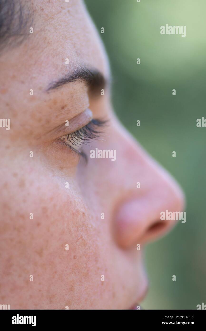 Close up of woman's eye looking away outdoors Stock Photo