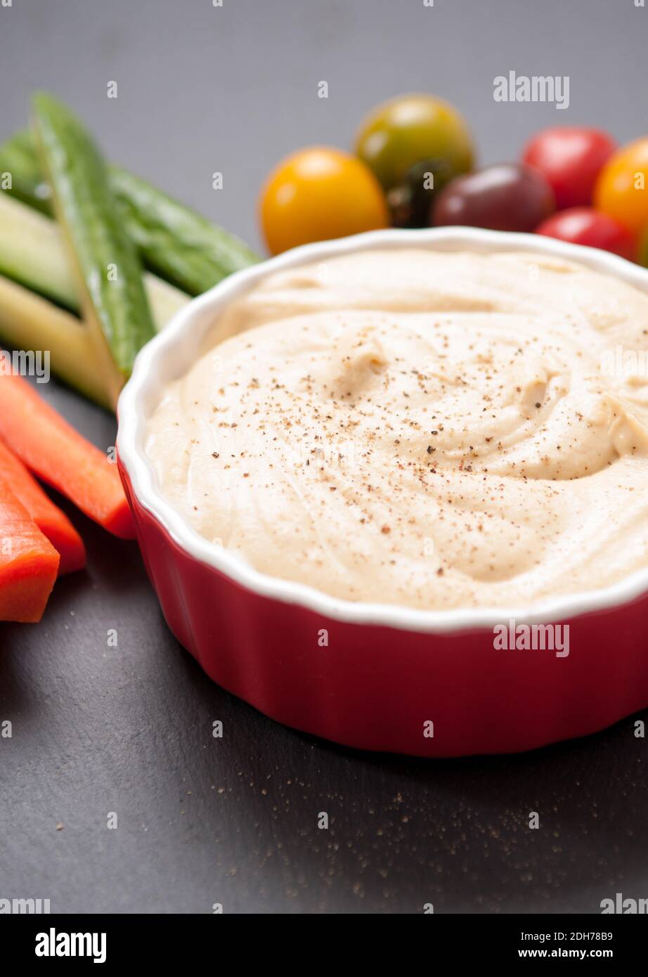 ground chickpea hummus with flatbreads and vegetables for dipping Stock Photo