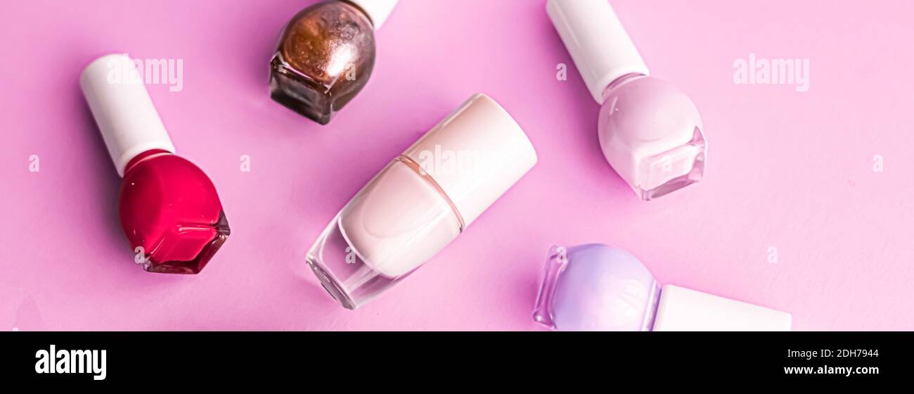 Nail polish bottles on pink background, beauty brand Stock Photo