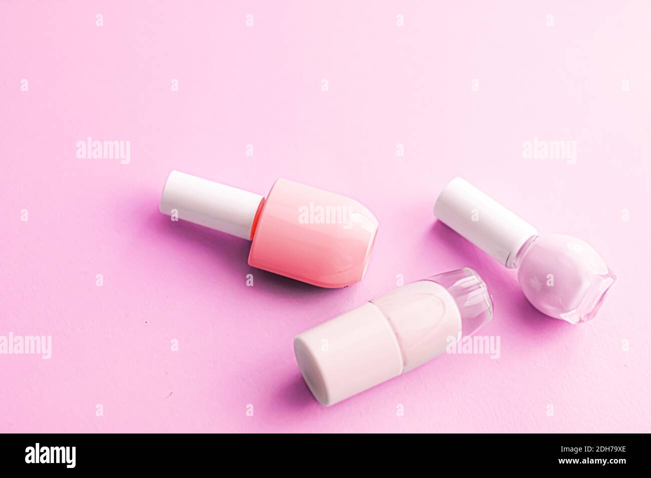 Nail polish bottles on pink background, beauty brand Stock Photo