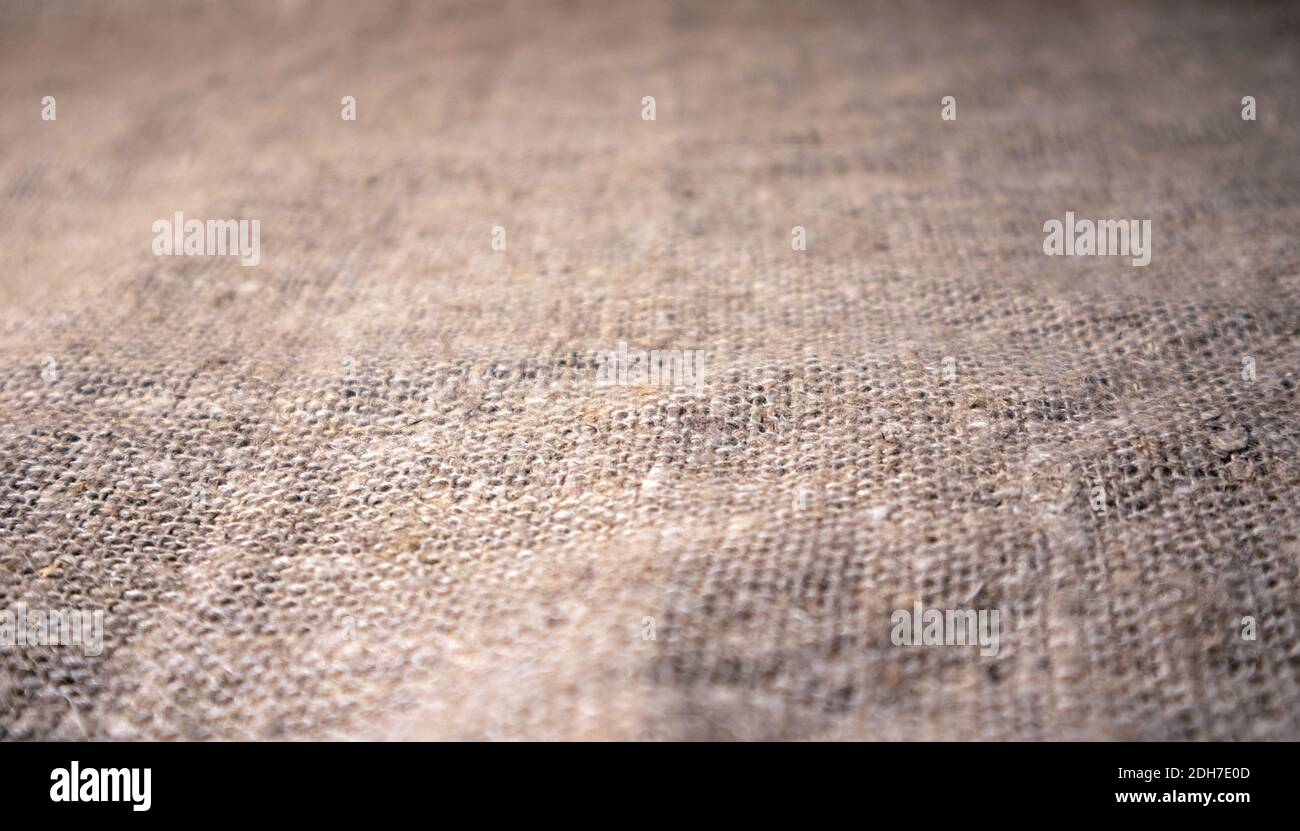 Rough burlap canvas with gradual defocus close up, natural textile background with space for content Stock Photo
