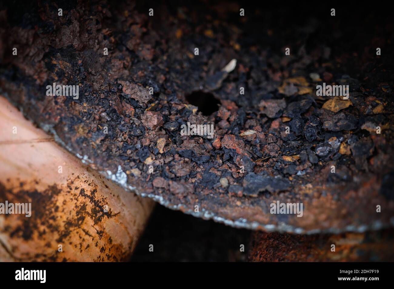 Shallow depth of field (selective focus) image with a very rusty metal pipe. Stock Photo