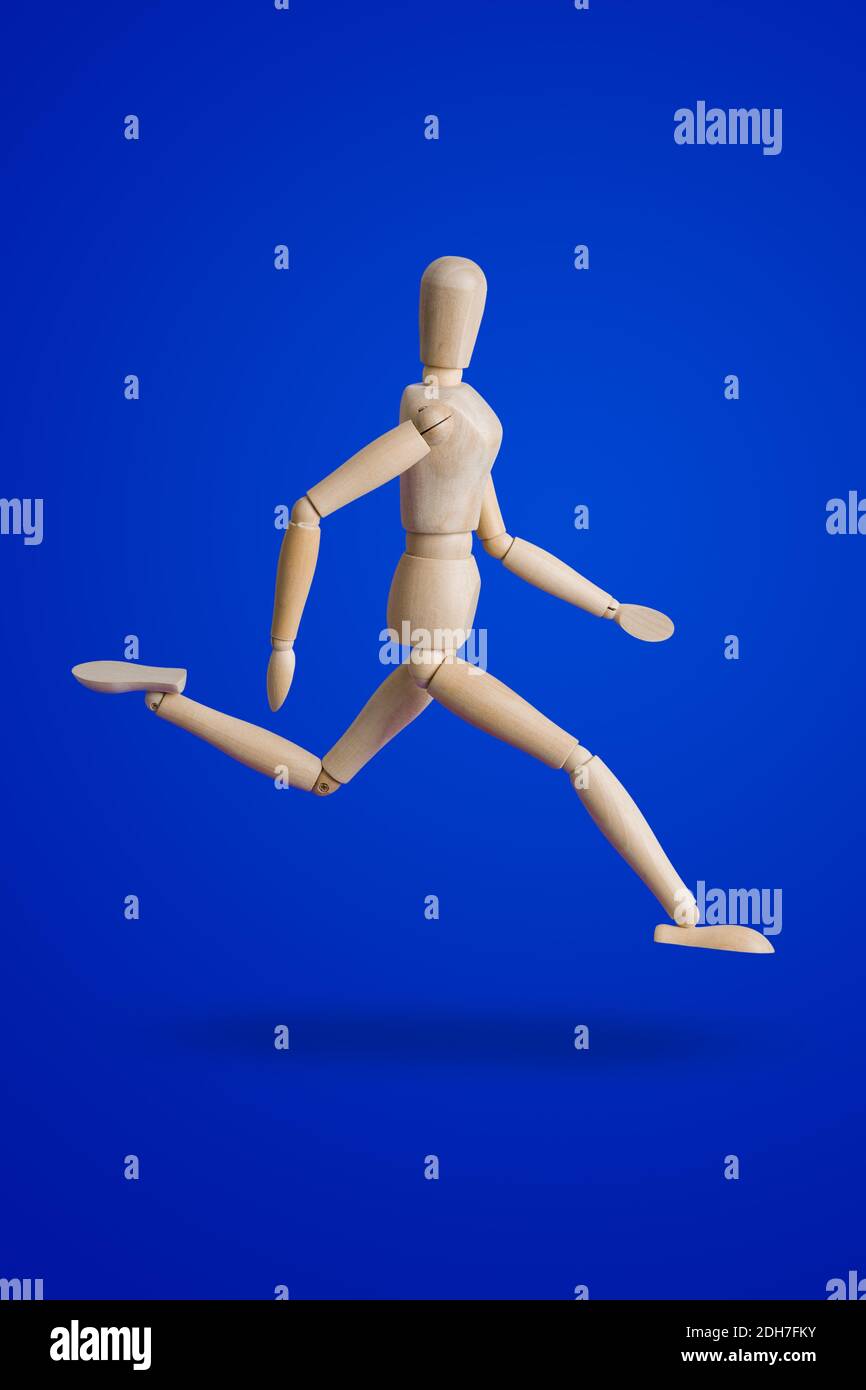 Sports wooden toy figure on blue Stock Photo