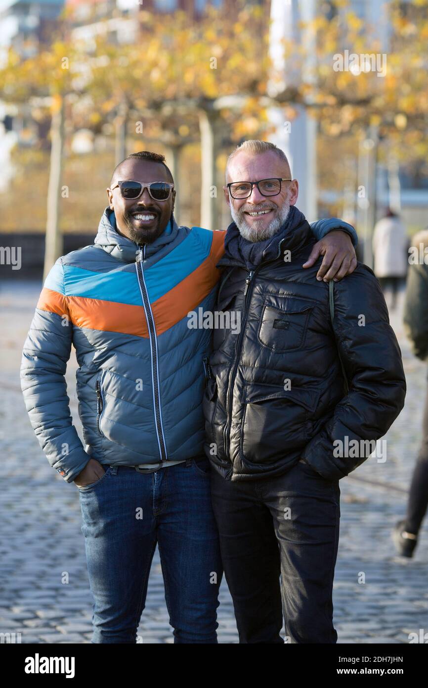 Happy gay mix-raced couple embracing, Frankfurt am Main, Hesse , Germany. Stock Photo