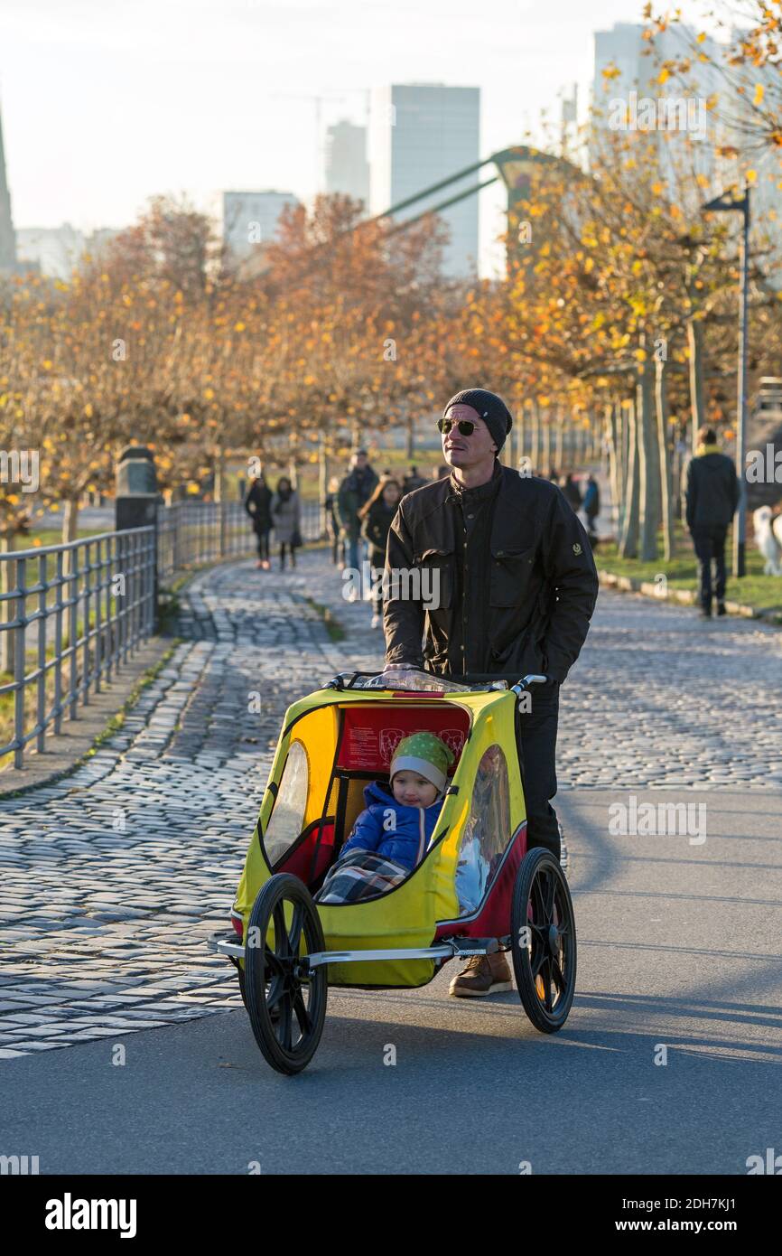 Father riding bicycle with child on it in  Frankfurt am Main, Hesse , Germany. Stock Photo