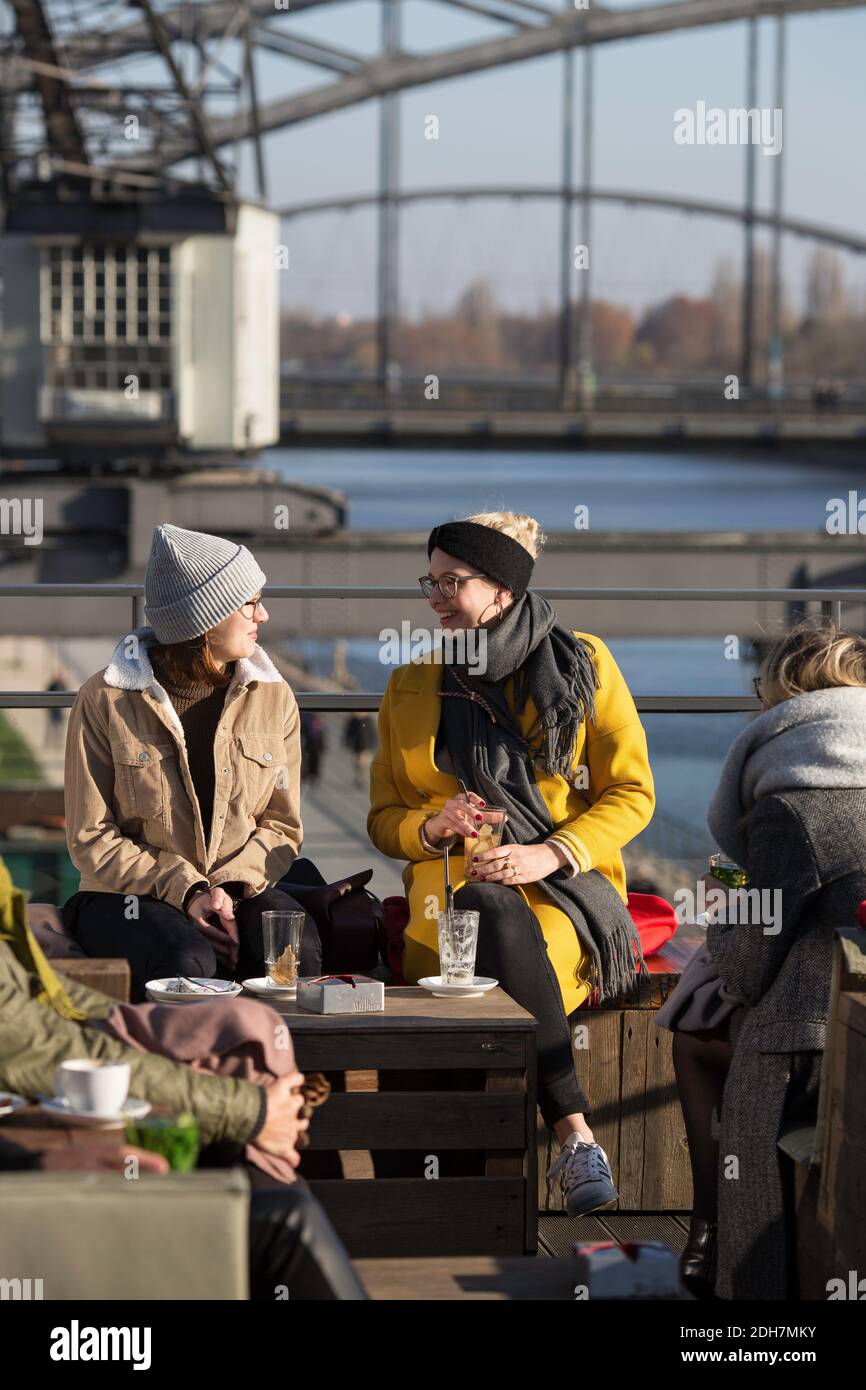 Germany, Hesse, Frankfurt, The bar Oosten with guests in the afternoon sun. Stock Photo