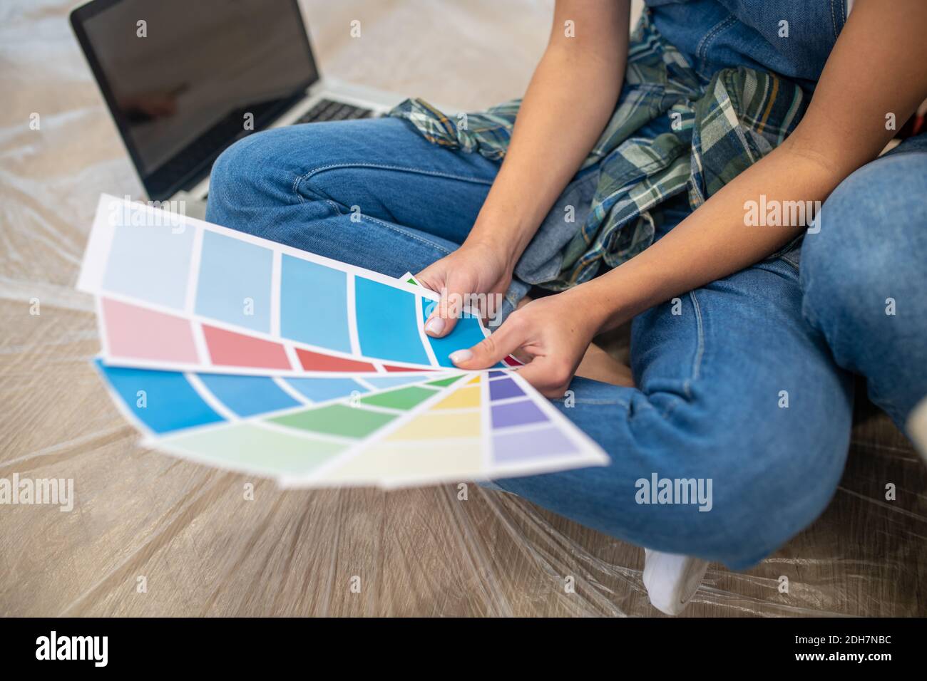 Close up of people sitting on the floor and discussing the color palette Stock Photo