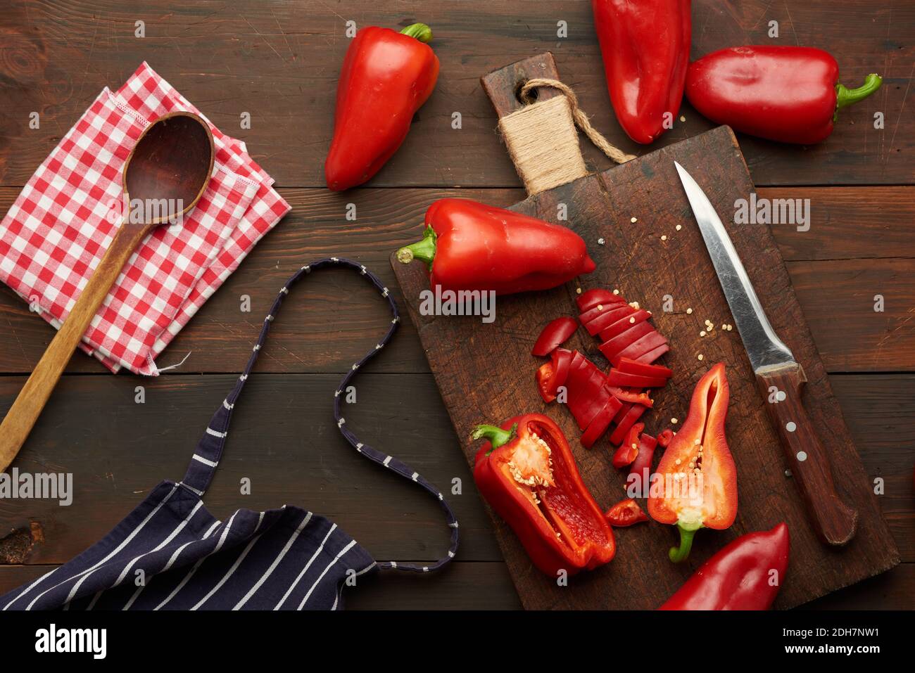 Sliced red pepper on a wooden board, brown wooden table Stock Photo - Alamy