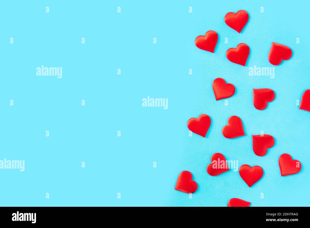 Red hearts on blue background. Stock Photo