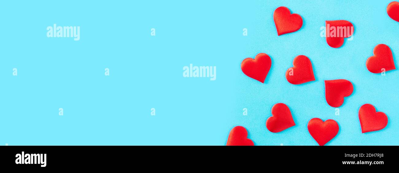Red hearts on blue background. Stock Photo