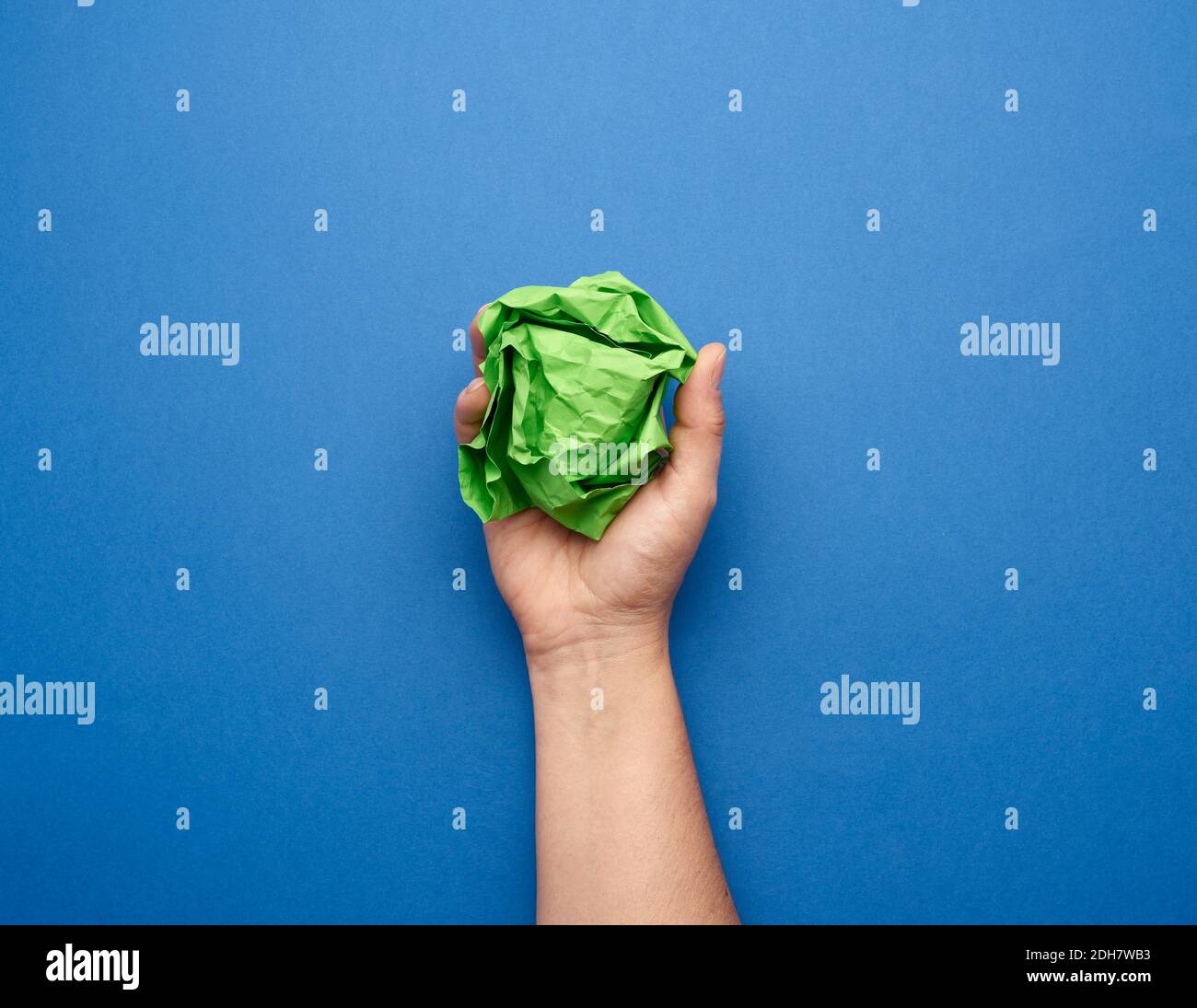 Hand holding crumpled sheet of paper hires stock photography and