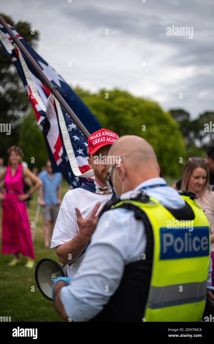 Melbourne, Victoria. 5 December 2020. Melbourne Freedom Rally. A Trump supporter speaks with police. Credit: Jay Kogler/Alamy Live News Stock Photo
