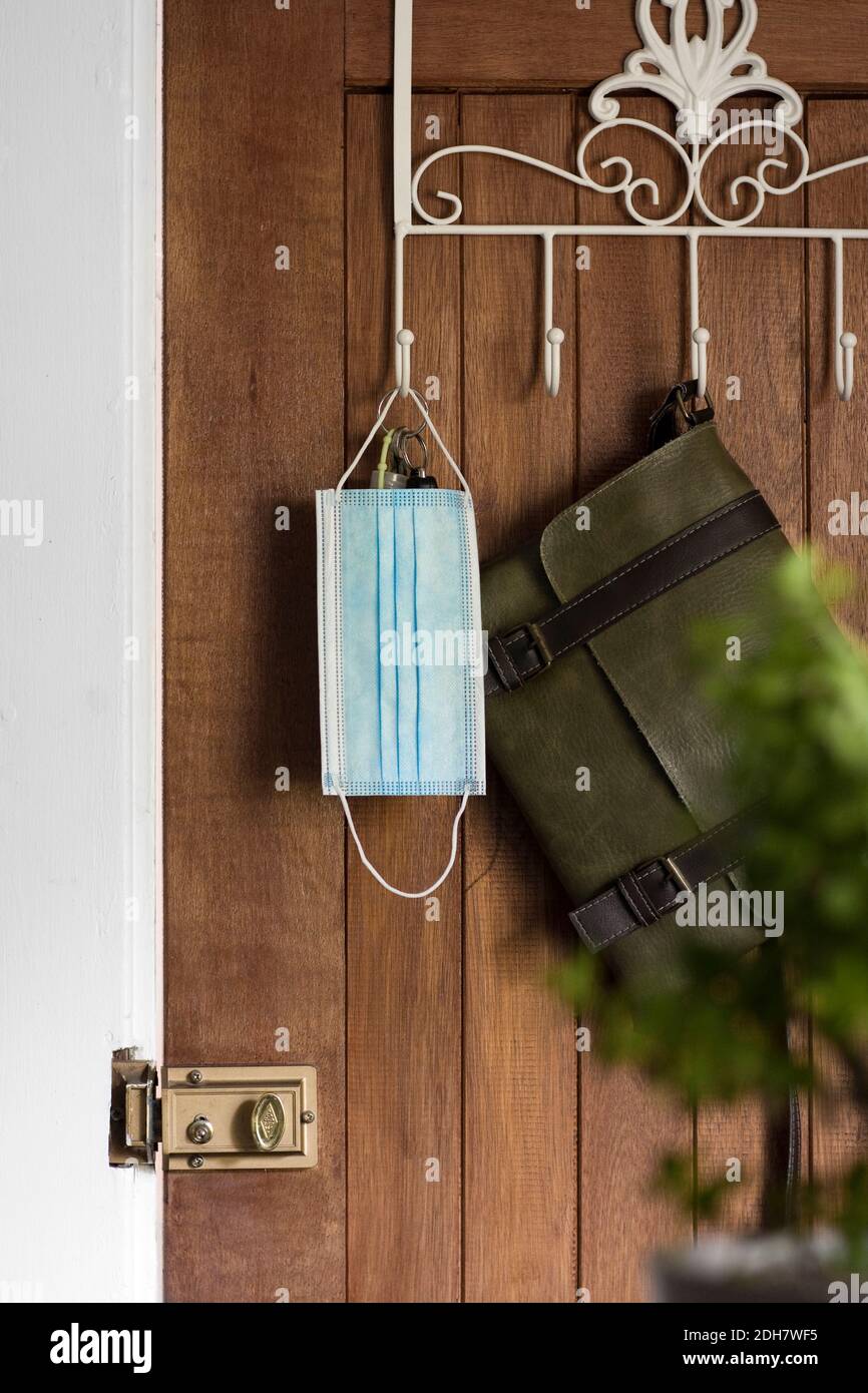 House and car keys, wallet, mobile phone and face mask on wooden surface.  Ready to go out in the new world Stock Photo - Alamy