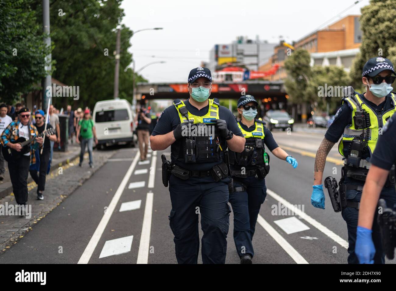 Melbourne, Victoria. 5 December 2020. Melbourne Freedom Rally. Police walk alongside protesters. Credit: Jay Kogler/Alamy Live News Stock Photo