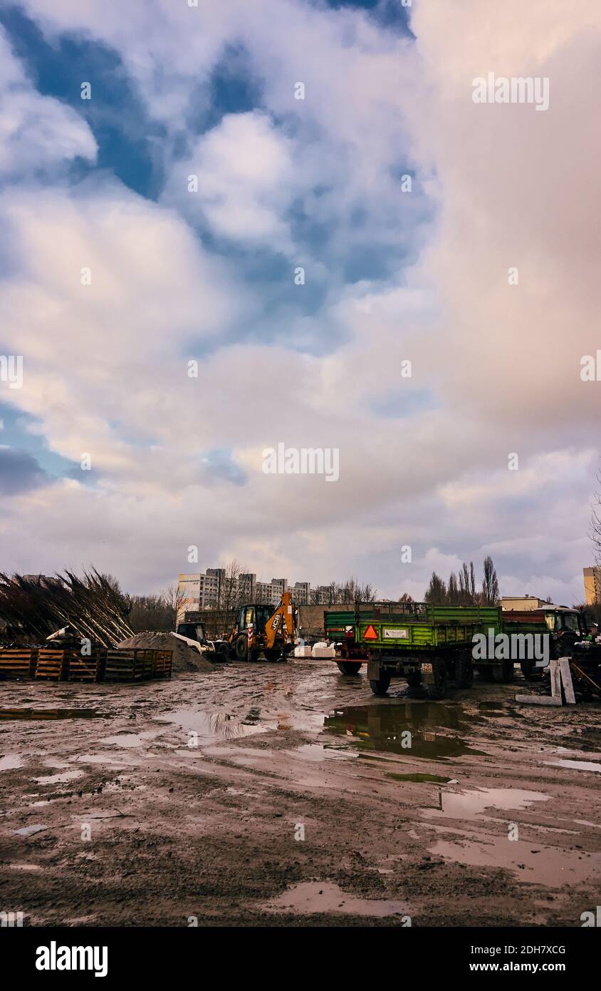 POZNAN, POLAND - Dec 17, 2017: Construction area with vehicles and apartment buildings in the distance in the Rataje park. Stock Photo