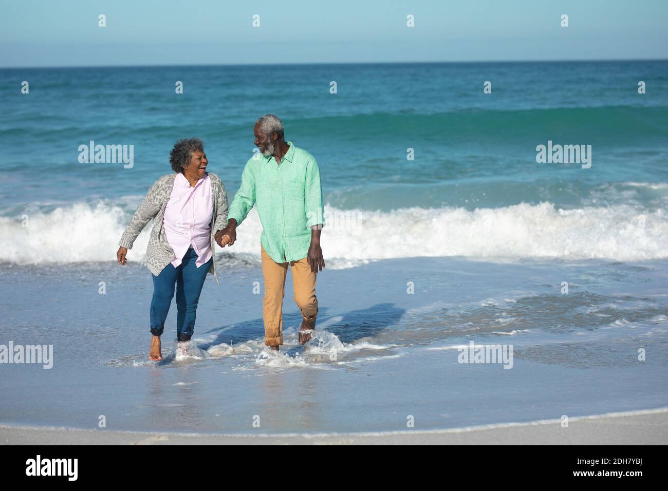 Old couple walking at the beach Stock Photo - Alamy